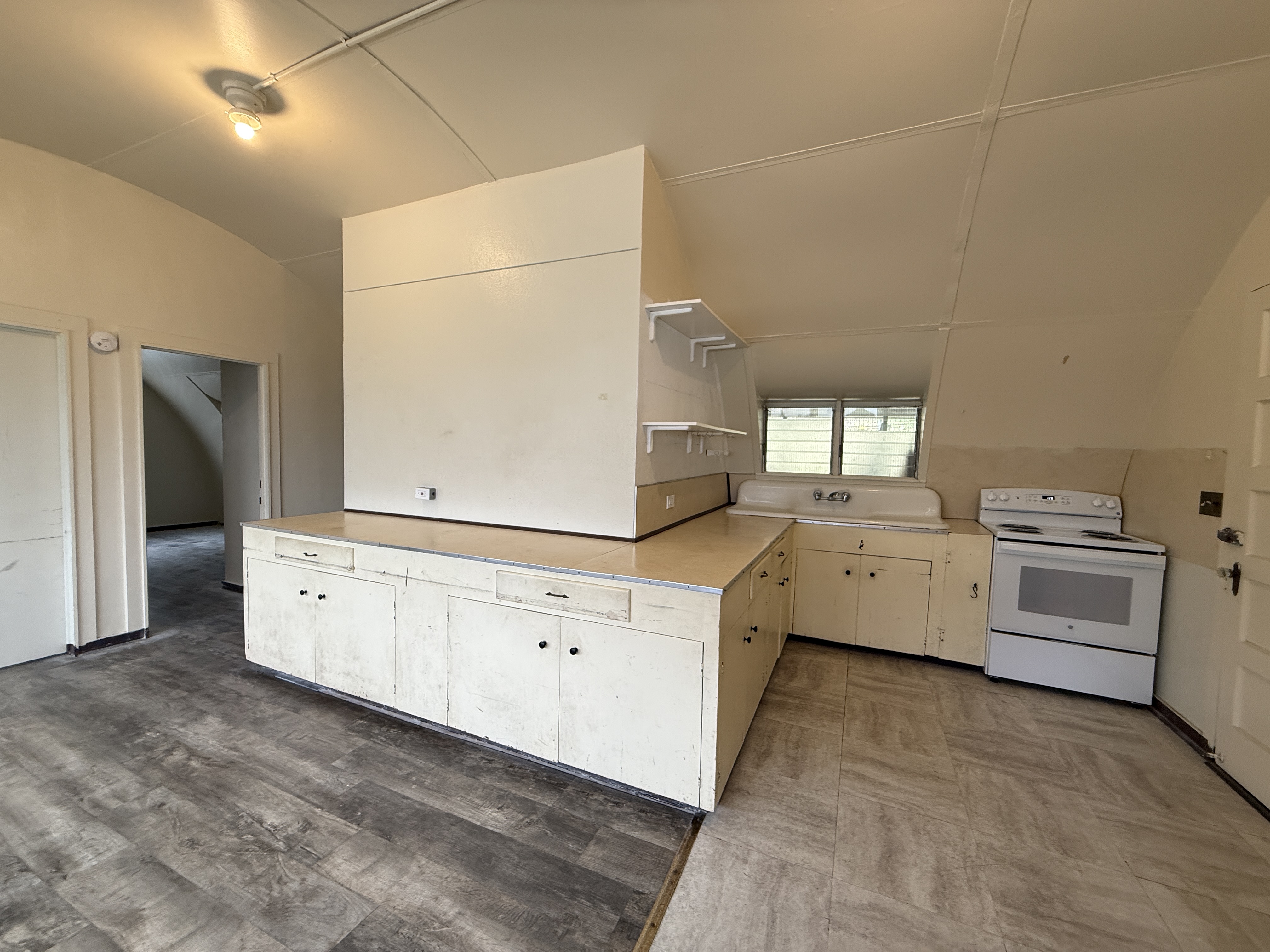 Kitchen cabinets before painting — worn and dated finish